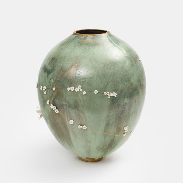 Vase kintsugi en céramique céladon vert de Karen Swami décoré de fleurs blanches en porcelaine.