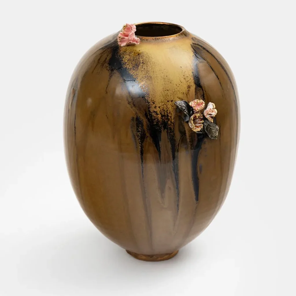 Brown and gold ceramic vase by Karen Swami featuring handcrafted floral appliqués.
