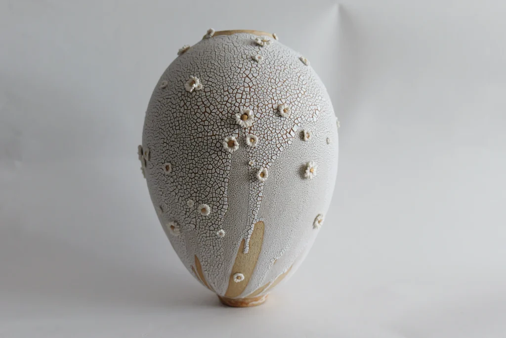 White crackle ceramic vase by Karen Swami with sculpted porcelain flowers.